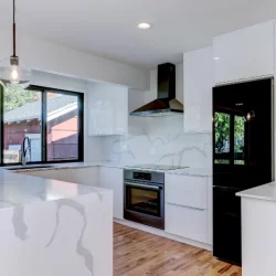 white marble counters with black kitchen appliances