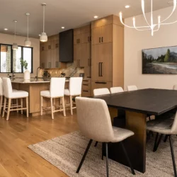 dining room/kitchen area in modern light and dark wood colored home