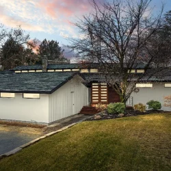 modern home with dark roof sunset in background