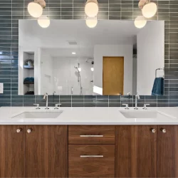 blue tile behind vanity mirror